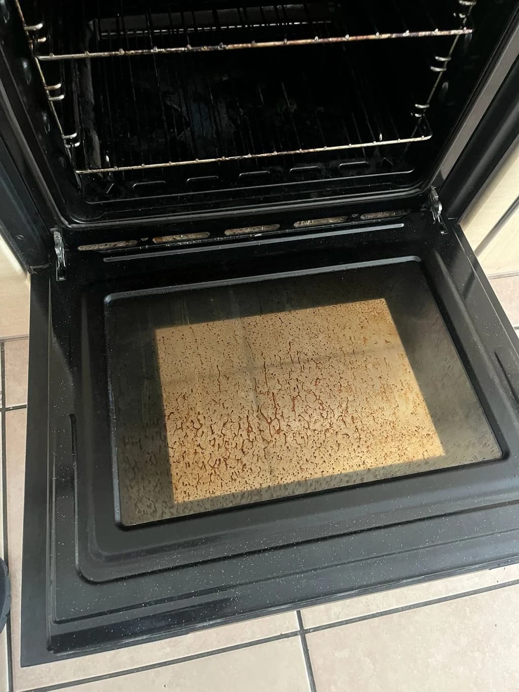 CDA oven interior and door glass caked in grease before cleaning