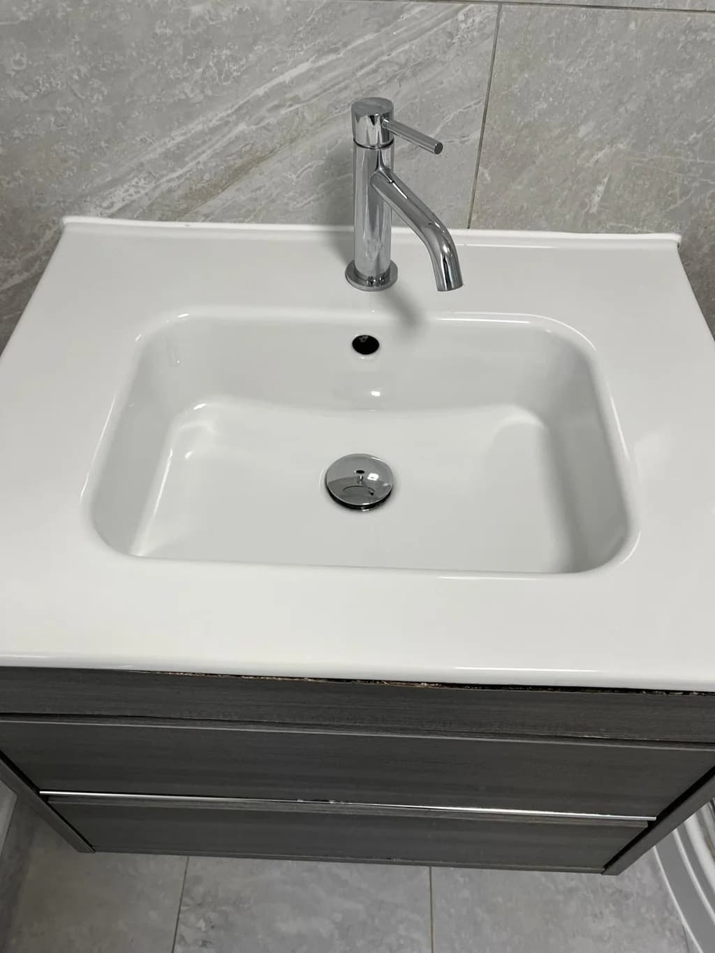 Vanity basin and chrome tap gleaming after clean